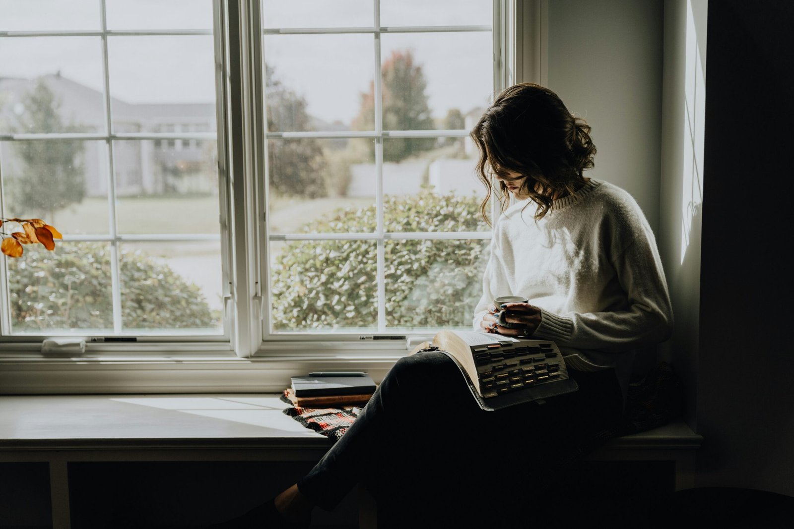 woman reading by the window